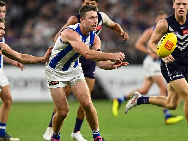 PERTH, AUSTRALIA - MARCH 25: Liam Shiels of the Kangaroos handpasses the ball during the 2023 AFL Round 02 match between the Fremantle Dockers and the North Melbourne Kangaroos at Optus Stadium on March 25, 2023 in Perth, Australia. (Photo by Daniel Carson/AFL Photos via Getty Images)