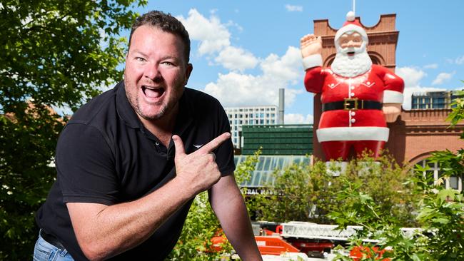 Andrew ‘Cosi’ Costello in front of the big Santa at the Adelaide Central Markets. Picture: Matt Loxton