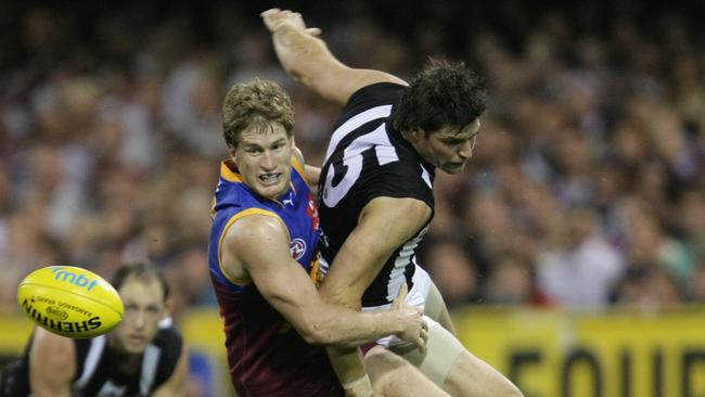 Luke Power tackles Collingwood’s Leigh Brown at the Gabba in 2009. Picture: David Kapernick