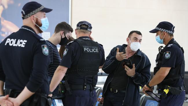 Police at Gold Coast Airport checking border passes of travellers from NSW. Picture Glenn Hampson