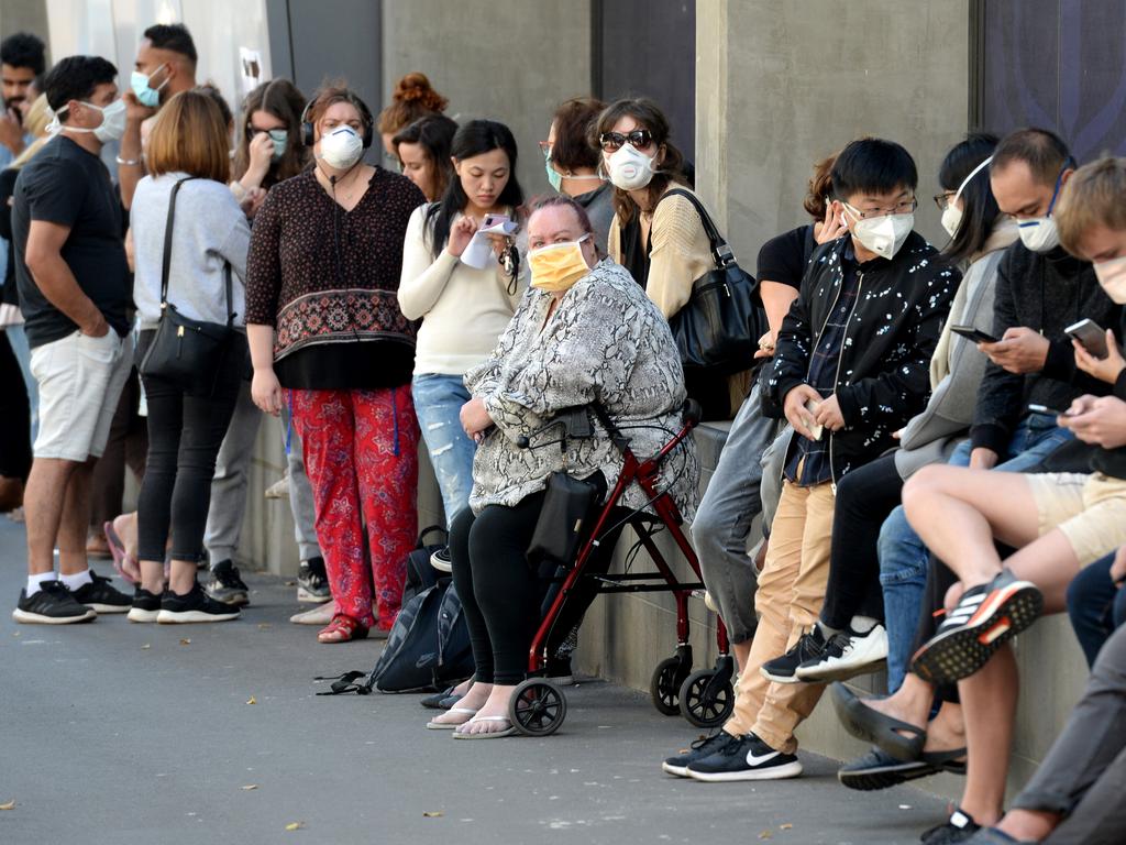 People queue outside the Royal Melbourne Hospital waiting to be be tested for the coronavirus. Picture: Andrew Henshaw