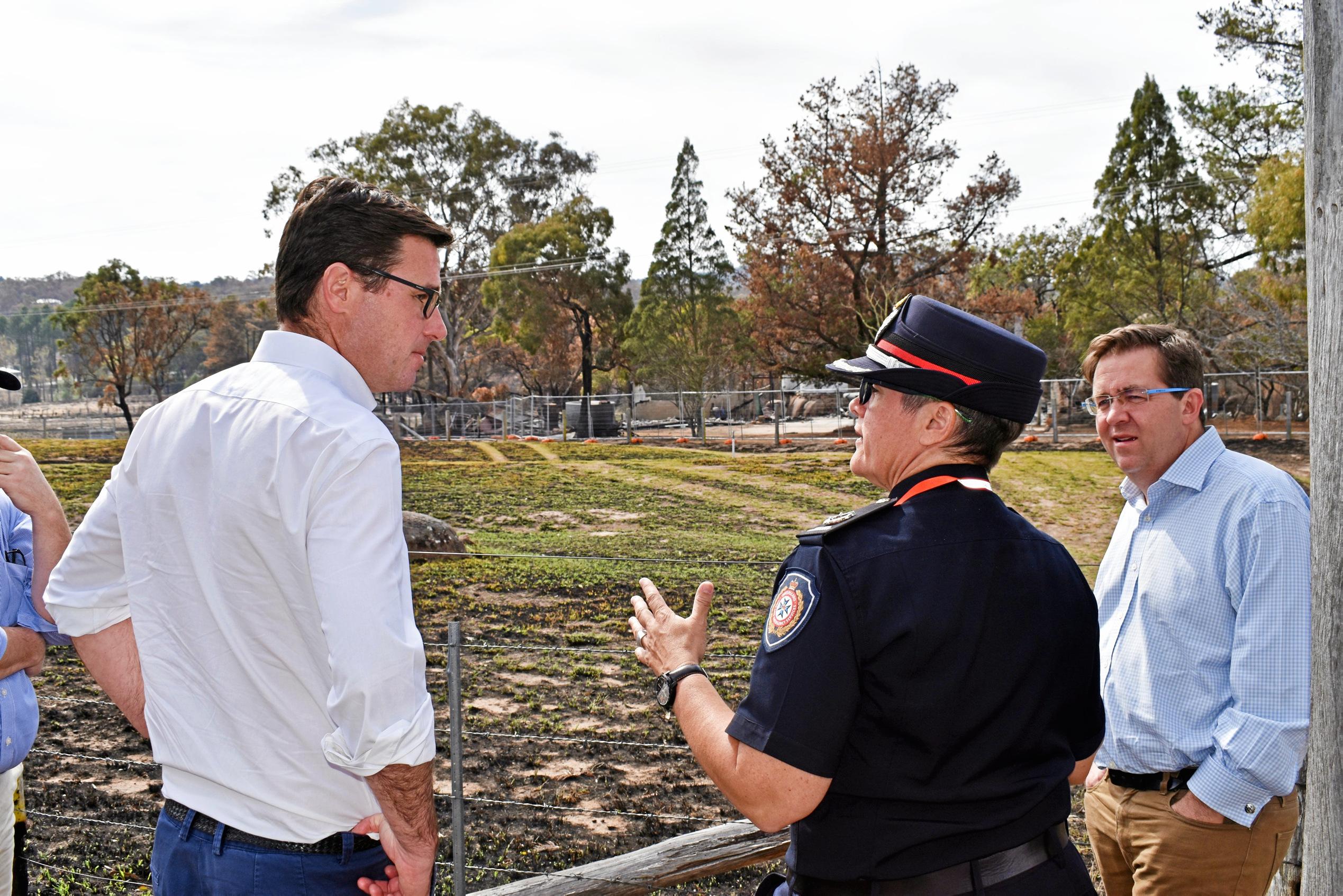 Minister for Natural Disaster and Emergency Management David Littleproud with QFES Assistant Commissioner Megan Stiffler. The pair look over one of the homes lost in last weeks bushfires.