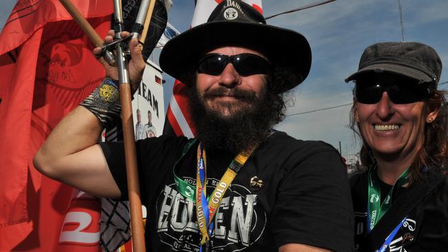 Anthony Hobden and long-term partner Gabrielle Johnson with their flags during the practice day at the V8 Supercar series at the Hidden Valley race track in Darwin in 2011. Picture: File