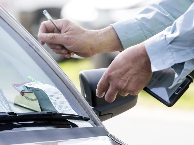 Parking data from across the city has shown a hot spot near Melbourne Zoo on Saturday afternoons. There were more than 6700 fines handed out in two carparks near the zoo in 2015/16. Illegally parked cars and parking inspectors booking illegally parkedd cars in and around carpark on POPLAR ROAD Parkville. Parking inspectors writes up a tickets for car illegally parked on the nature strip.