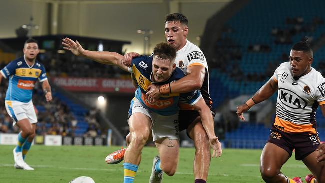 GOLD COAST, AUSTRALIA - MARCH 19: AJ Brimson of the Titans is tackled by Jordan Riki of the Broncos during the round two NRL match between the Gold Coast Titans and the Brisbane Broncos at Cbus Super Stadium on March 19, 2021, in Gold Coast, Australia. (Photo by Matt Roberts/Getty Images)