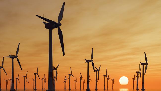 Offshore wind turbine farm at sunset.