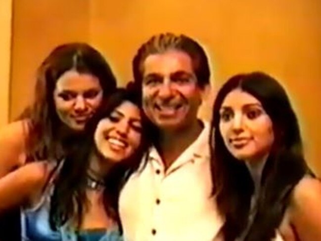Khloe, Kourtney and Kim with their late father Robert in a moment from the video.