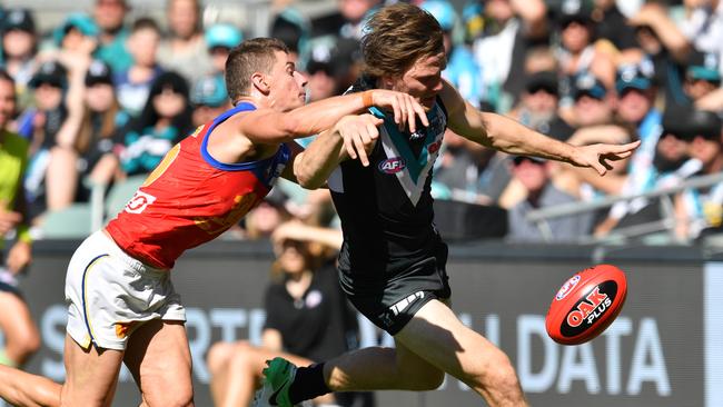 Jared Polec under pressure from Brisbane’s Dayne Zorko Adelaide Oval on Saturday. Picture: AAP Image/David Mariuz