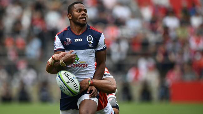 Reds' wing Filipo Daugunu is tackled by Sunwolves' wing Hosea Saumaki.