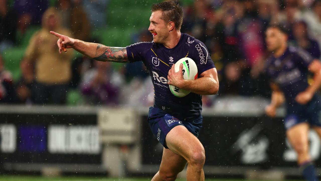 MELBOURNE, AUSTRALIA - APRIL 06: Cameron Munster of the Storm makes a break to score a try during the round six NRL match between the Melbourne Storm and Sydney Roosters at AAMI Park on April 06, 2023 in Melbourne, Australia. (Photo by Graham Denholm/Getty Images)