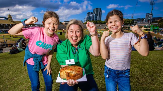 Ekka 2023 – Cake judging. Luella, 9 and Claudette Meynink, 8 celebrate with Chelse Dunne who came second with her pineapple upside down cake. Picture: Nigel Hallett