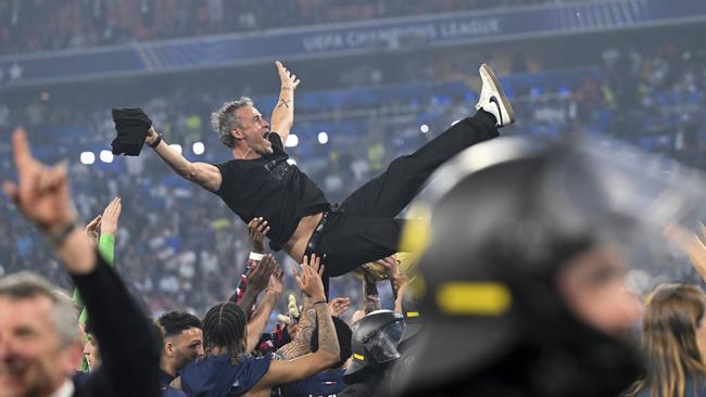PSG's coach Luis Enrique is thrown into the air by his players. (Sven Hoppe/dpa via AP)