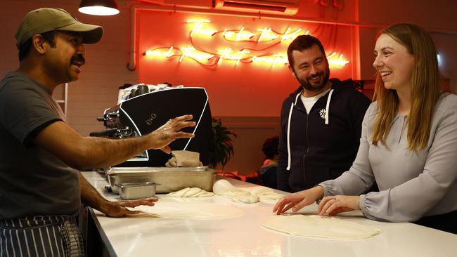 Sarah Dixon and Stuart Rowan learning the art of Roti making by Kafe Kooks Roti Master, Suresh Rajandran. Picture: Jonathan Ng