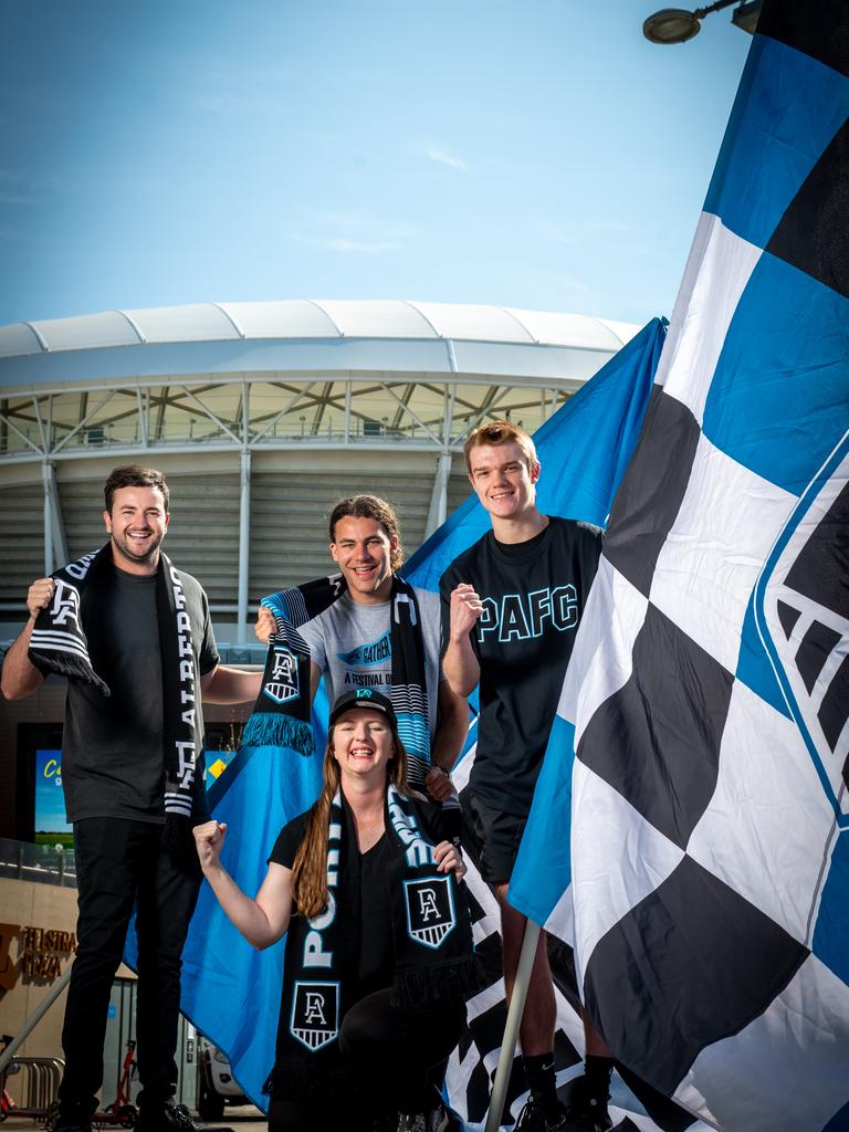 Power fans Kane Stubbs, Dylan Errington, Lee McEwan and Nathan Brooks will be among those marching from Festival Plaza across the footbridge into Adelaide Oval before the game on Saturday night. Picture: Naomi Jellicoe