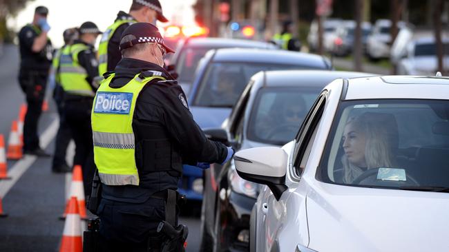 Police perform random checks on drivers and passengers at a coronavirus checkpoint. Picture: Andrew Henshaw