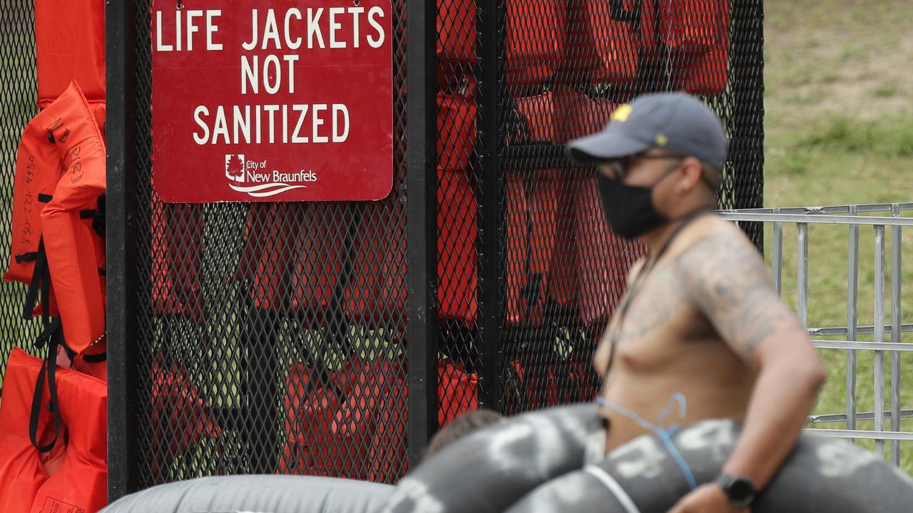 A man in a mask walks past life jackets in Texas where cases are surging. Picture: Eric Gay/AP