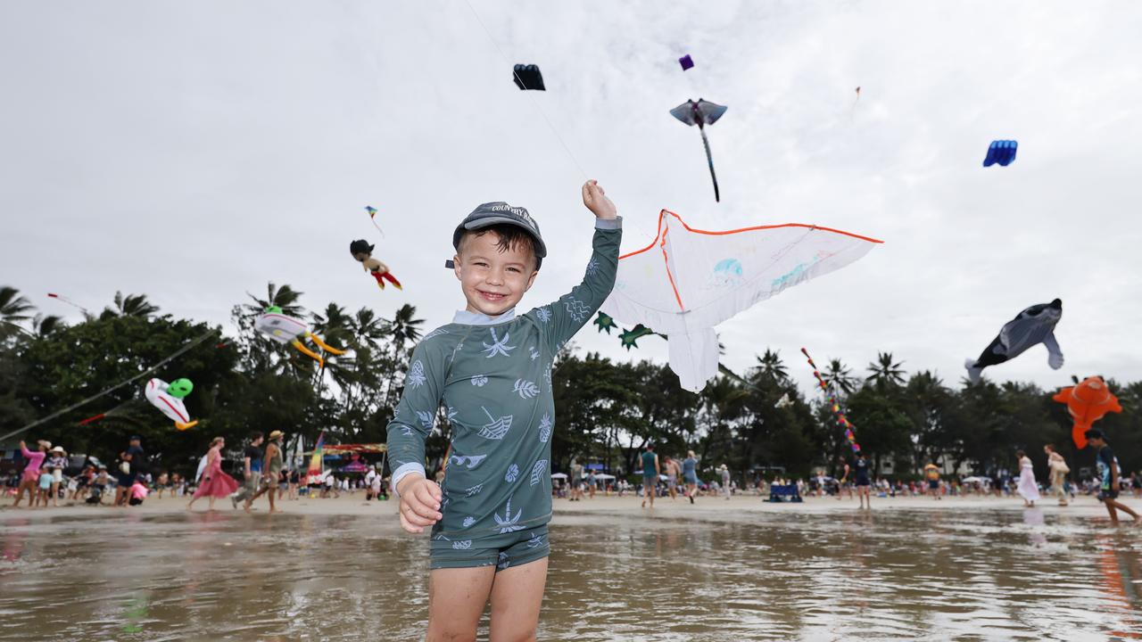 Bohdi Hook, 3, flies a kite which is dwarfed by the huge kites flying above Four Mile Beach when the attended Port Douglas Carnivale's family beach day on Saturday. Picture: Brendan Radke