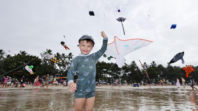 Bohdi Hook, 3, flies a kite which is dwarfed by the huge kites flying above Four Mile Beach when the attended Port Douglas Carnivale's family beach day on Saturday. Picture: Brendan Radke