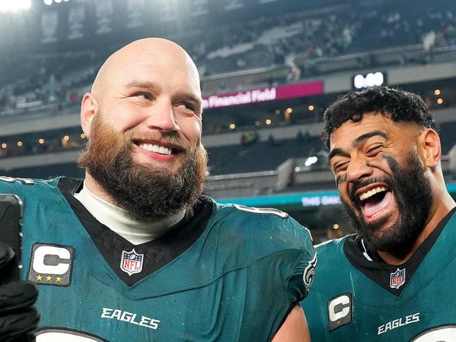 PHILADELPHIA, PENNSYLVANIA - JANUARY 12: Lane Johnson #65 and Jordan Mailata #68 of the Philadelphia Eagles celebrate beating the Green Bay Packers 22-10 during the NFC Wild Card Playoff at Lincoln Financial Field on January 12, 2025 in Philadelphia, Pennsylvania.   Mitchell Leff/Getty Images/AFP (Photo by Mitchell Leff / GETTY IMAGES NORTH AMERICA / Getty Images via AFP)