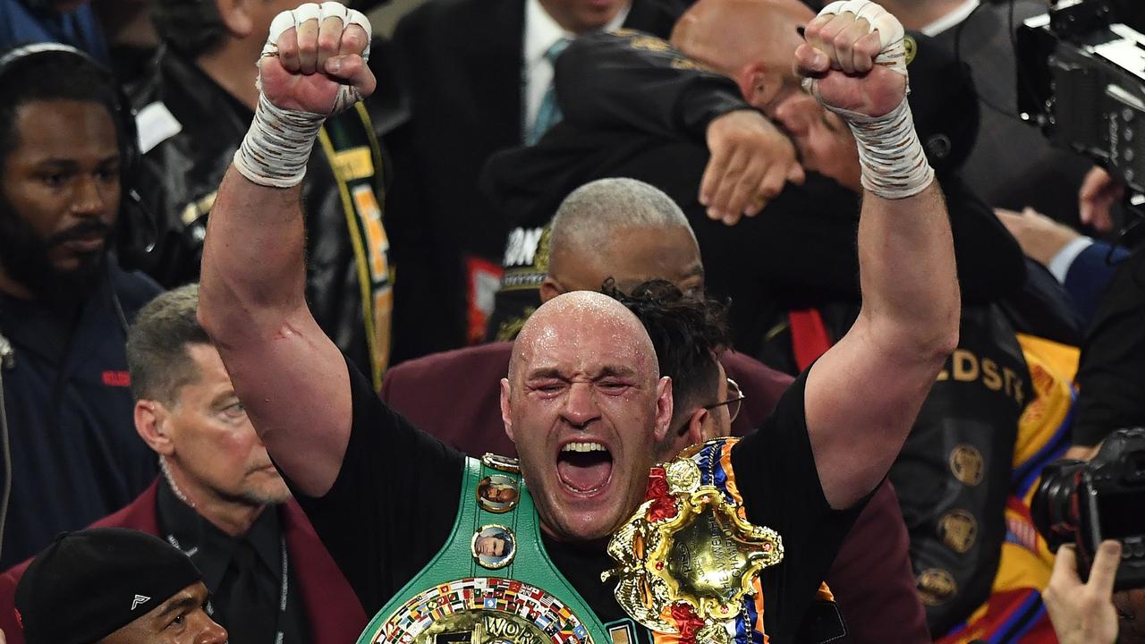 Tyson Fury celebrates after defeating Deontay Wilder to claim the WBC belt.