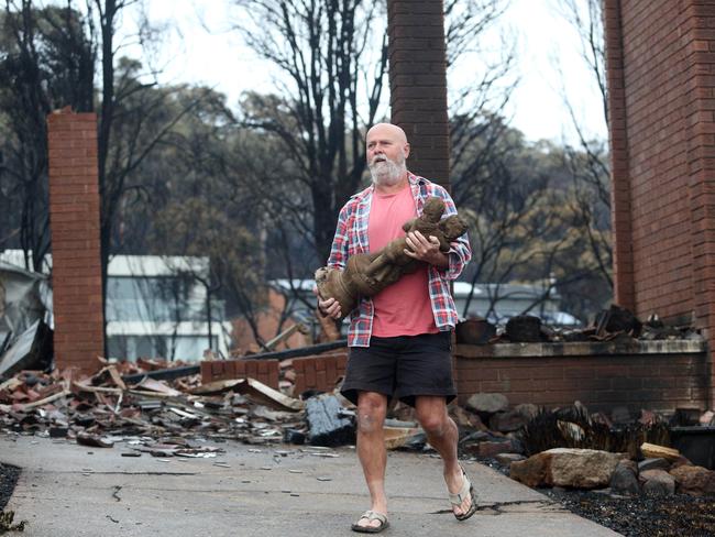 Peter Inkster recovered a statue from the burnt out home of his 84-year-old mother-in-law. Picture: Gary RamageMr Inkster loads the special statue onto his ute. Picture: Gary Ramage