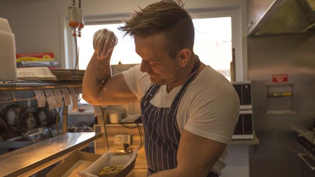 Chef Garrison in the kitchen of Hotel Bruny cooking free meals for the community.