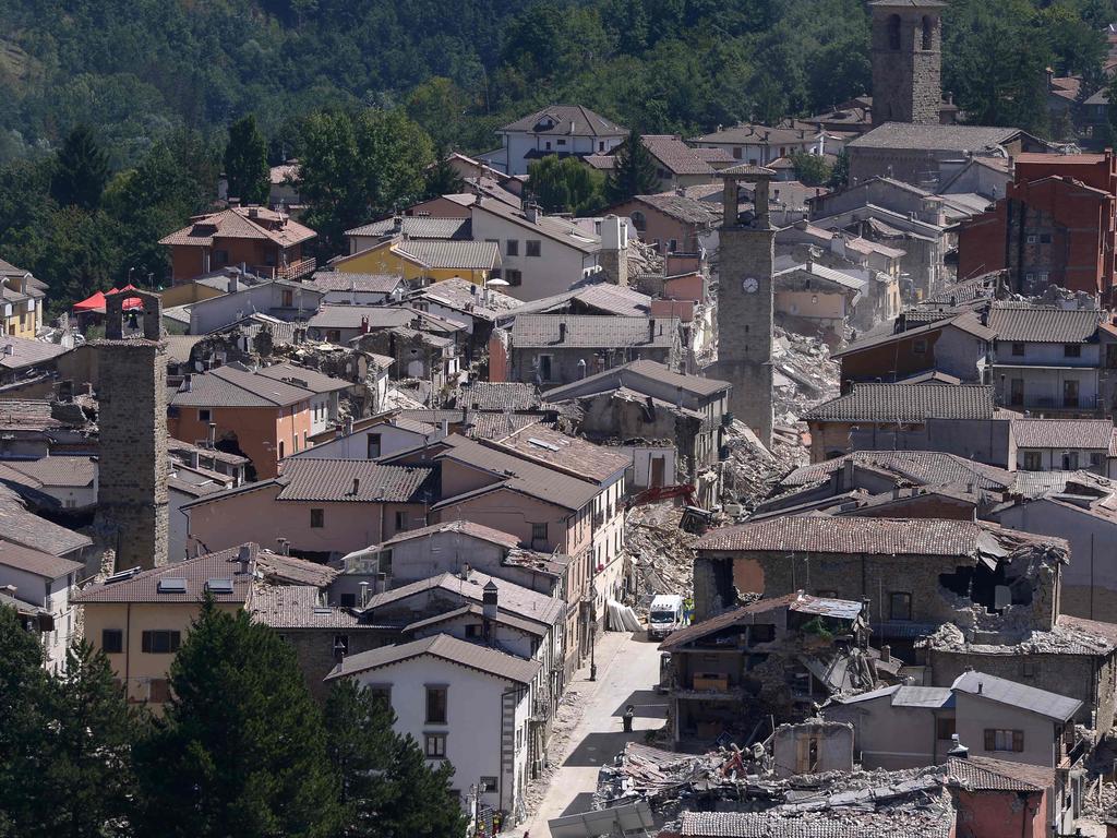 TOPSHOT - Partial view of the damaged central Italian village of Amatrice, taken on August 25, 2016, a day after a 6.2-magnitude earthquake struck the region killing some 247 people. The death toll from a powerful earthquake in central Italy rose to 247 on August 25, 2016 amid fears many more corpses would be found in the rubble of devastated mountain villages. Rescuers sifted through collapsed masonry in the search for survivors, but their grim mission was clouded by uncertainty about exactly how many people had been staying in communities closest to the epicentre of the quake of August 24. / AFP PHOTO / FILIPPO MONTEFORTE