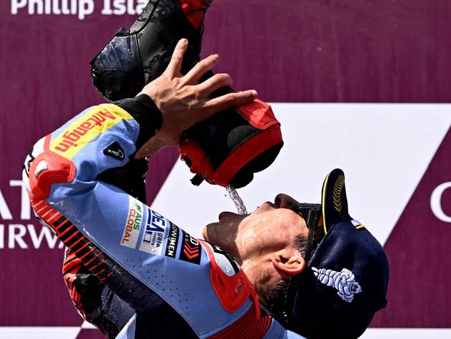 TOPSHOT - Gresini Racing MotoGP team rider Marc Marquez of Spain drinks from his boot after winning the MotoGP Australian Grand Prix on Phillip Island on October 20, 2024. (Photo by William WEST / AFP) / -- IMAGE RESTRICTED TO EDITORIAL USE - STRICTLY NO COMMERCIAL USE --