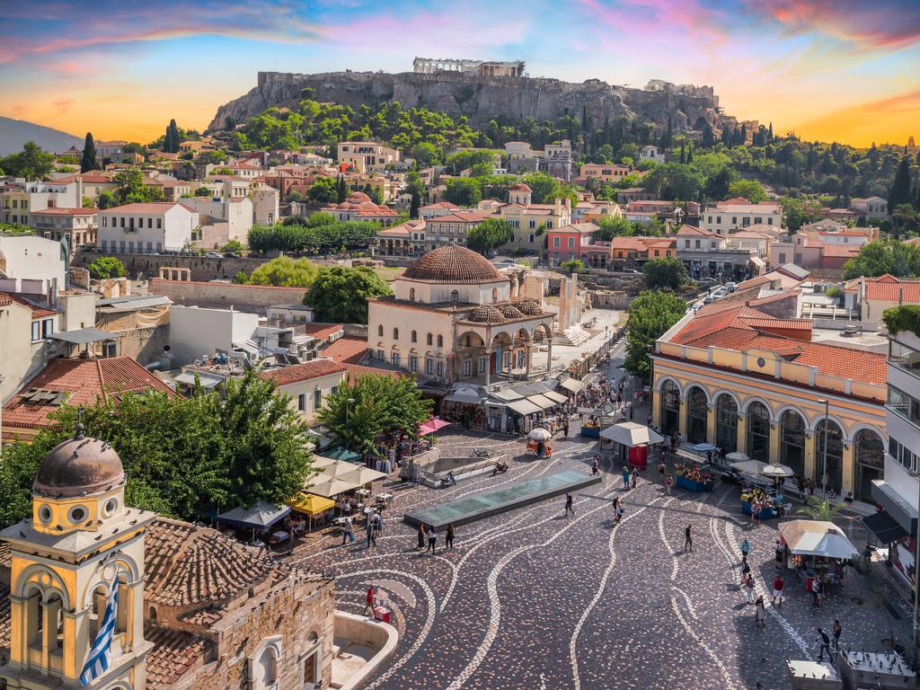 Aerial view of popular Monastiraki square with the church of Pantanassa and the city view with the Acropolis site and Parthenon on the hill.