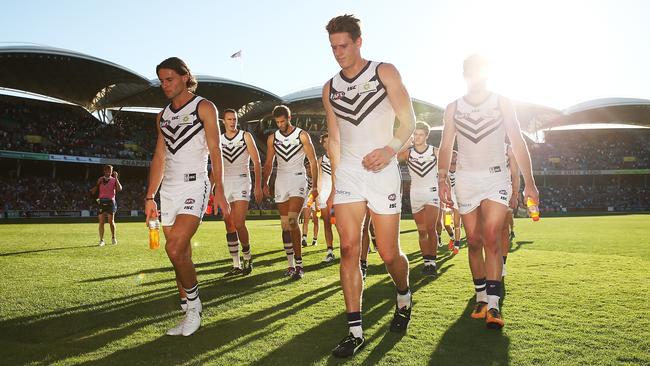 Fremantle players exit Adelaide Oval.