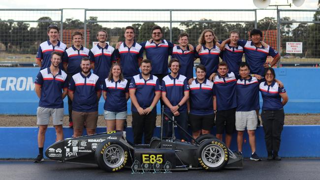 Soaking in victory. The UOW Motorsport team with their vehicle and trophies. Photo: Contributed