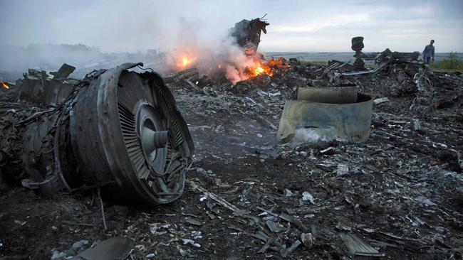 A man walks amongst the debris at the crash site of a passenger plane near the village of Grabovo, Ukraine, Thursday, July 17, 2014. Ukraine said a passenger plane carrying 295 people was shot down Thursday as it flew over the country, and both the government and the pro-Russia separatists fighting in the region denied any responsibility for downing the plane. Picture: Dmitry Lovetsky