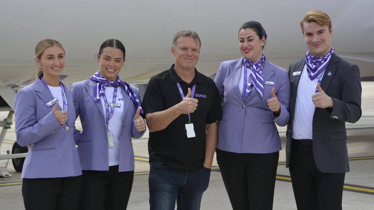 Bonza CEO Tim Jordan (centre) with members of the cabin crew at the first flight by the carrier from Melbourne to Toowoomba Wellcamp Airport.