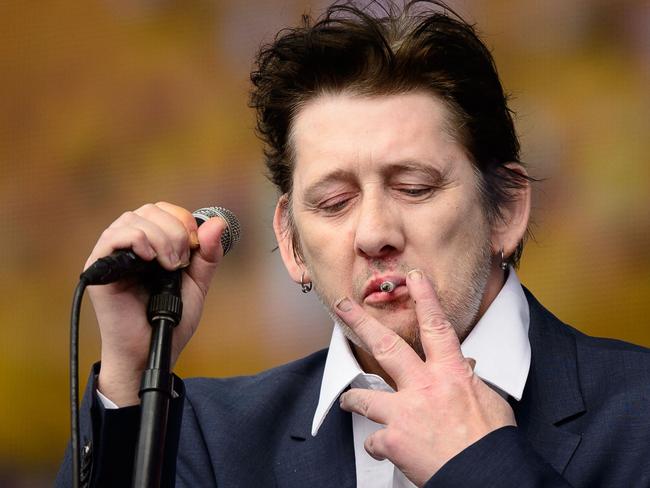 (FILES) Shane MacGowan of British group The Pogues performs on stage at the British Summer Time festival in Hyde Park in central London, on July 5, 2014. Shane MacGowan, songwriter and lead singer of folk-punk group The Pogues, has died aged 65 after a long illness, his wife announced on November 30, 2023. (Photo by LEON NEAL / AFP)