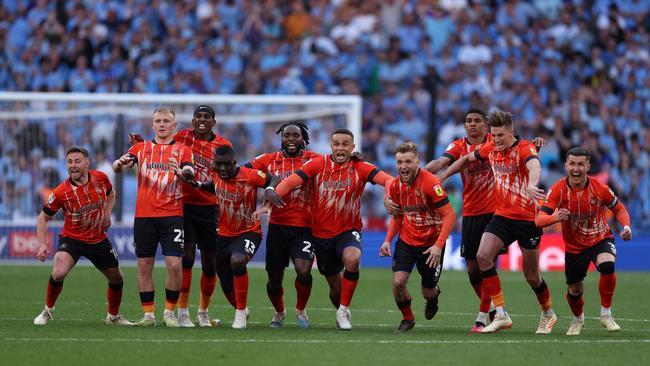 Luton Town players celebrate after Fankaty Dabo of Coventry City (not pictured) misses a penalty. (Photo by Richard Heathcote/Getty Images)