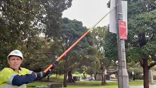 An Ausgrid worker pictured removing Allegra Spender’s campaign posters from poles in 2022. Picture: Supplied