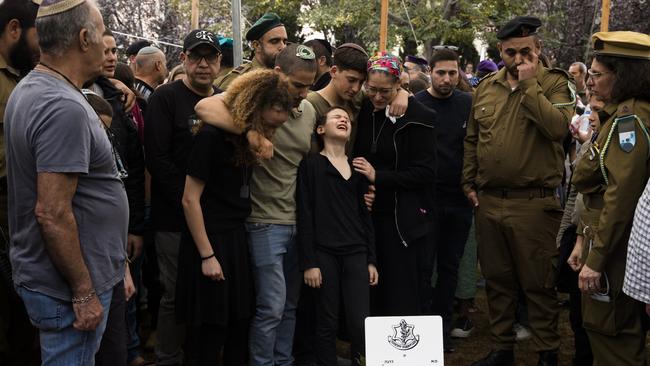 KFAR SABA, ISRAEL - DECEMBER 12:  Family members react during a funeral for  Maj. (res.) Eviatar Cohen on December 12, 2023 in Kfar Saba, Israel. Maj. (res.) Eviatar Cohen, 42, served in the 5th Brigade's 8111st Battalion, and was from Kfar Saba. The Israel Defense Forces announced yesterday that he was killed fighting in southern Gaza, where Israel has expanded its ground campaign in recent weeks.  (Photo by Amir Levy/Getty Images) *** BESTPIX ***