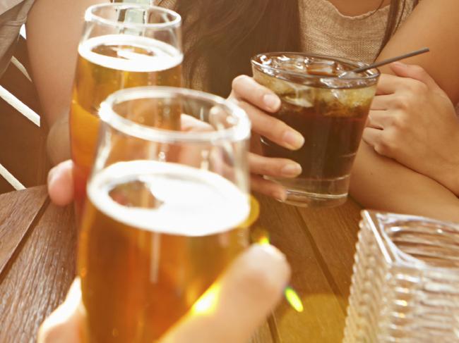 Group Of Friends Enjoying Drink At Outdoor Rooftop Bar