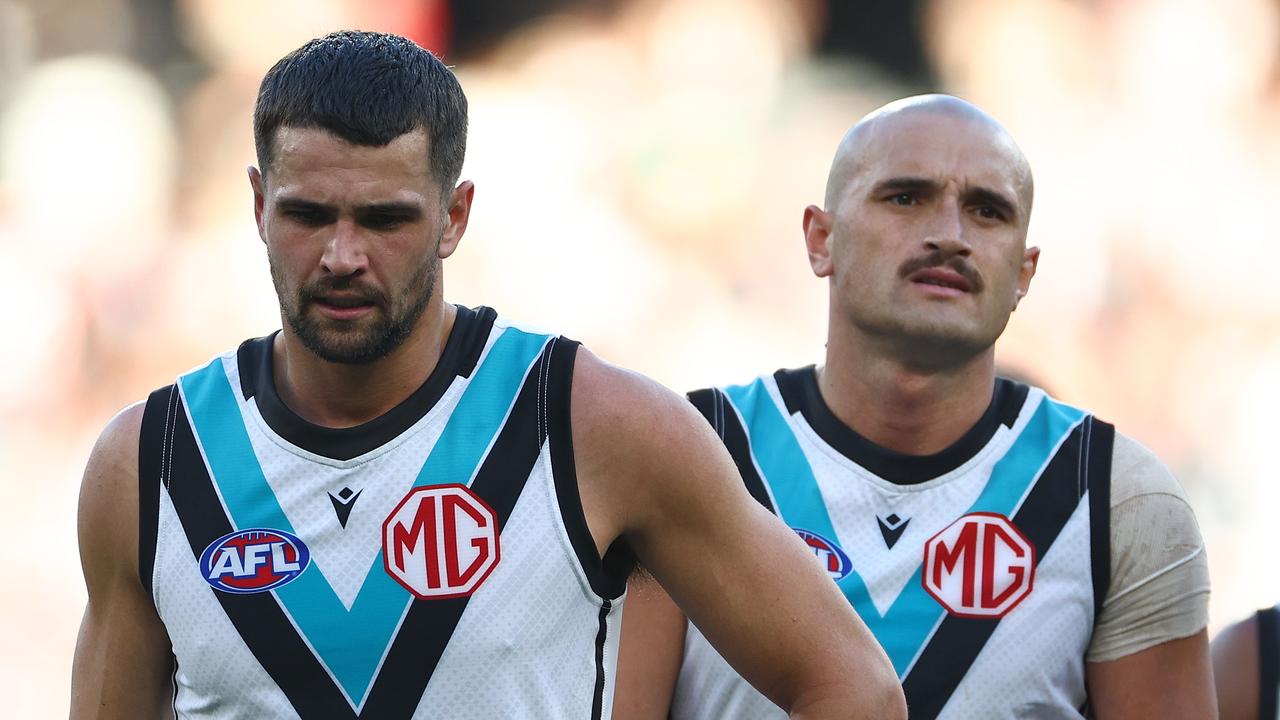 MELBOURNE, AUSTRALIA - APRIL 20: Ryan Burton and Sam Powell-Pepper of the Power look dejected after losing the round six AFL match between Collingwood Magpies and Port Adelaide Power at Melbourne Cricket Ground, on April 20, 2024, in Melbourne, Australia. (Photo by Quinn Rooney/Getty Images)