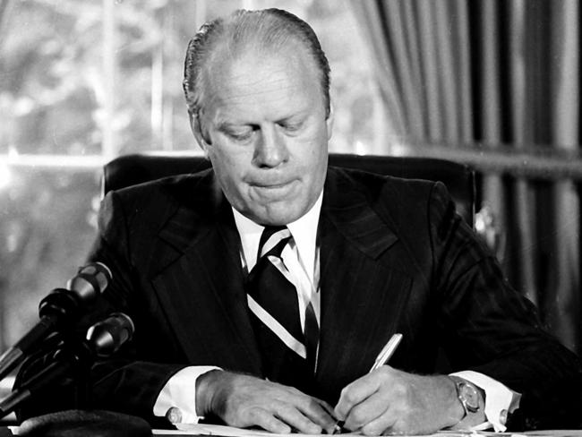 USA politician President Gerald R. Ford signing document granting former President Richard M. Nixon "full, free and absolute pardon" for "offences against the United States" at the White House in Washington 08 Sep 1974. 1970s