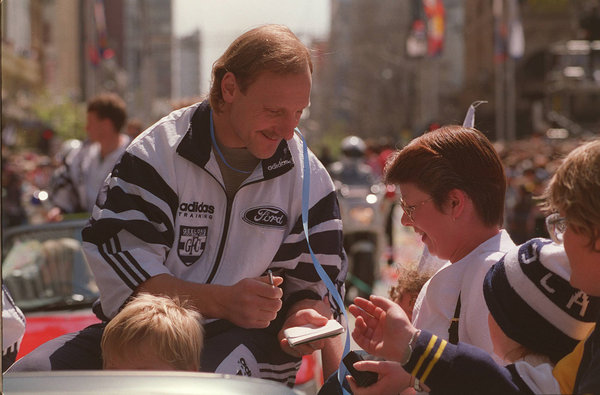 <p>2: GARY ABLETT, SNR. Geelong co-captain Gary Ablett, Snr, is surrounded by fans during 1995 AFL grand final parade through Melbourne streets. The Geelong legend was slected in the AFL Team of the Century, Geelong Football Club Team of the Century. Ablett holds the record for most goals in a Grand Final, with nine goals and one behind in 1989, and is the only player to have won the Coleman Medal and kicked 100 goals in three consecutive seasons. Picture: Ian Currie</p>