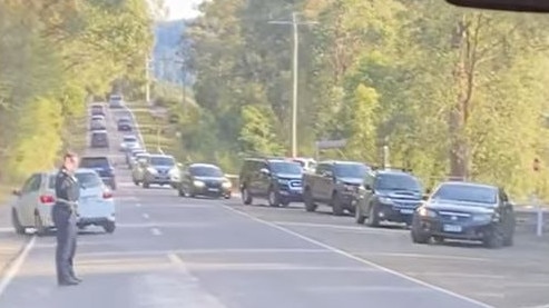 Police are seen directing traffic and turning away cars on their way to the Redwood Forest after it reopened. Picture: Cooper Murray