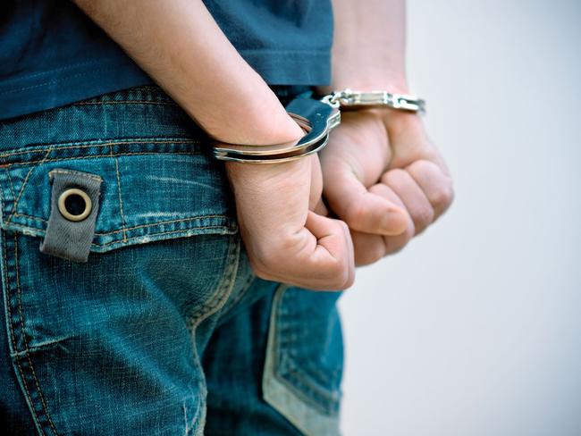 Generic Thinkstock image of youth crime - hand cuffs teenager under arrest.