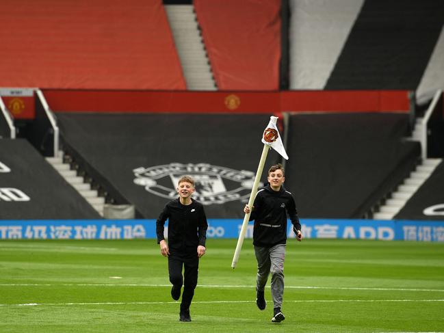 A young fan steals a corner post.