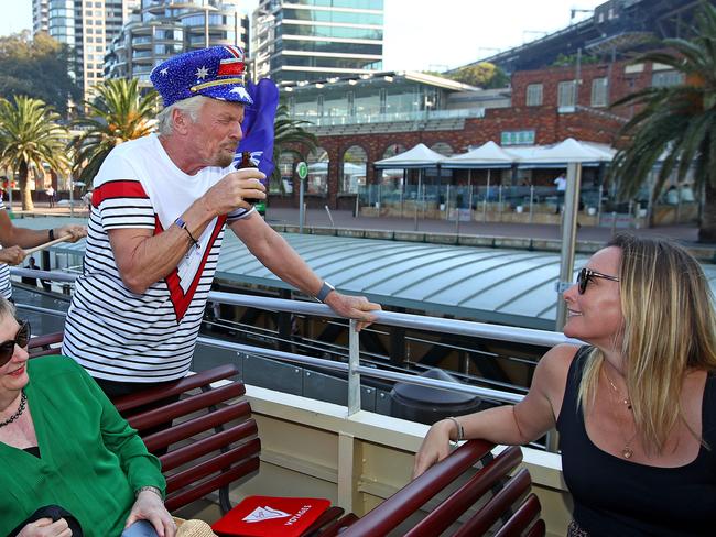 Sir Richard Branson greets commuters and tries a cold brew coffee. Picture: Toby Zerna