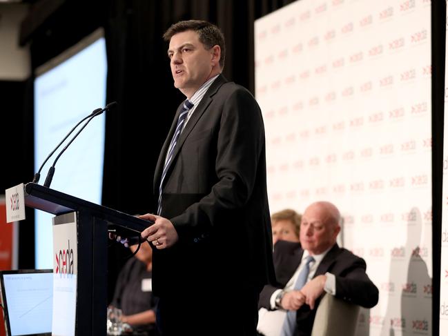 Paul Italiano of TransGrid at the CEDA lunch held at the Four Seasons Hotel in Sydney while AGL's Andy Vesey "listens on in the background.  Photo Chris Pavlich