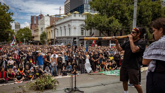 An Aboriginal man plays the didgeridoo for the crowd during the Invasion Day Rally on January 26, 2024 in Melbourne, Australia. (Photo by Tamati Smith/Getty Images)