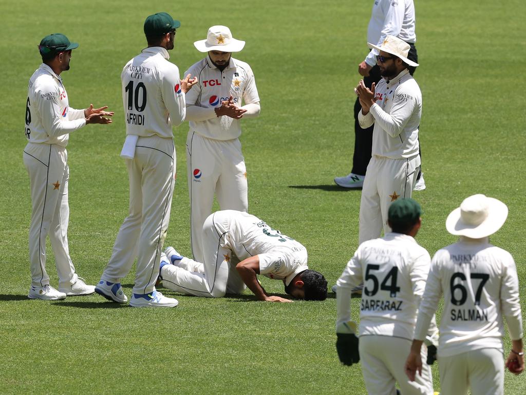 Aamir Jamal kisses the turf after taking six on debut.