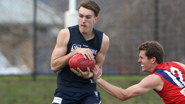 Harrison Macreadie of Northern marks under pressure from Peter McEvoy of Coburg during VFL footy: Northern Blues v Coburg on Saturday, August 11, 2018, in Epping, Victoria, Australia. Picture: Hamish Blair