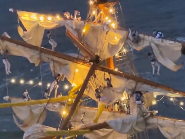 Crew members dangle from ropes after the Mexican navy tall ship crashed struck the Brooklyn Bridge. Picture: Instagram
